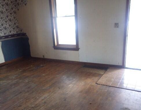 empty room with dark wood-type flooring