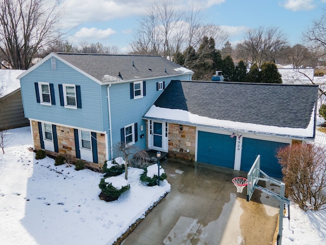 traditional home featuring a garage, stone siding, roof with shingles, and concrete driveway