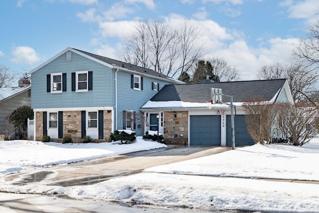 view of front of home featuring stone siding, a shingled roof, an attached garage, and driveway