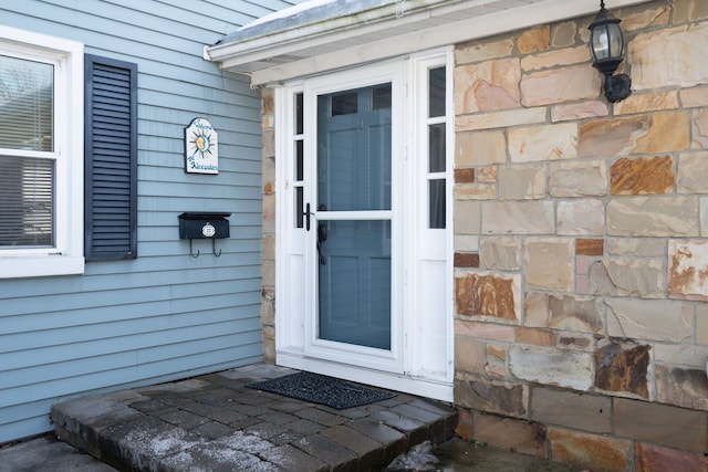 entrance to property featuring stone siding