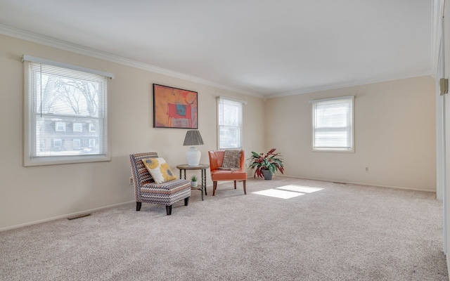 sitting room featuring carpet floors, visible vents, and crown molding