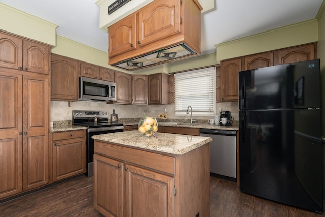 kitchen with dark wood finished floors, appliances with stainless steel finishes, ornamental molding, a sink, and backsplash