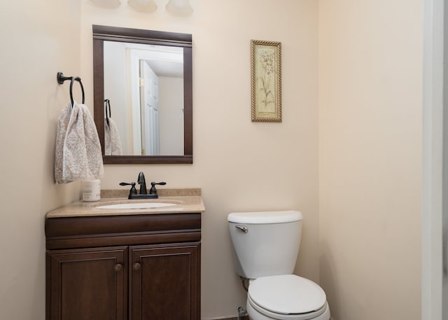 half bathroom with toilet and vanity