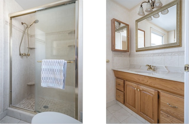 bathroom featuring crown molding, tile walls, a shower stall, vanity, and tile patterned floors