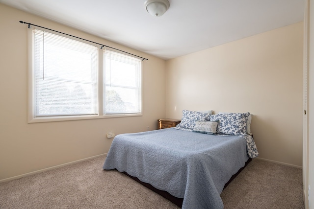 carpeted bedroom with baseboards