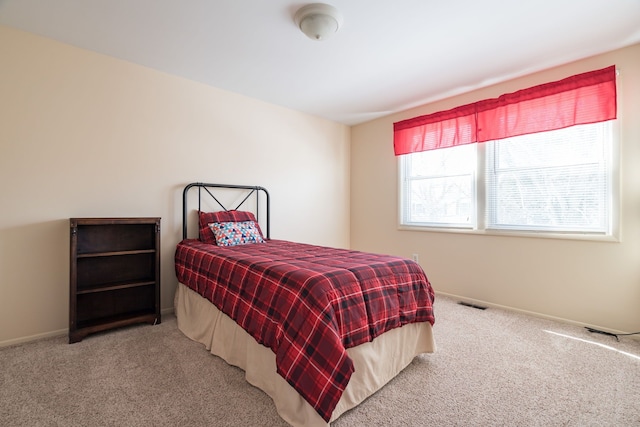 bedroom featuring carpet, visible vents, and baseboards