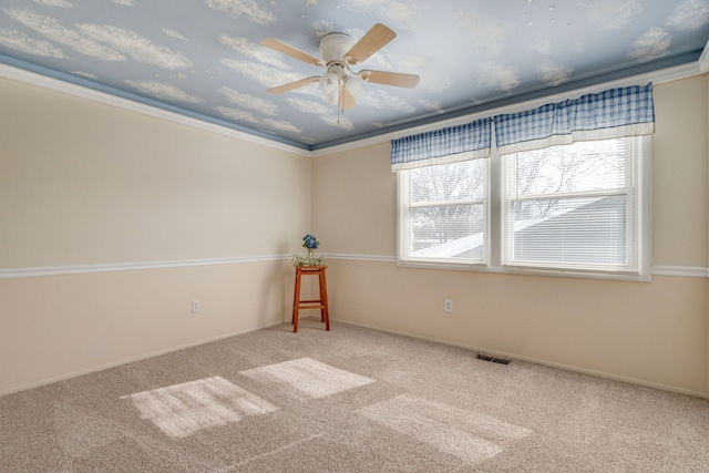 unfurnished room with carpet floors, a wealth of natural light, and visible vents