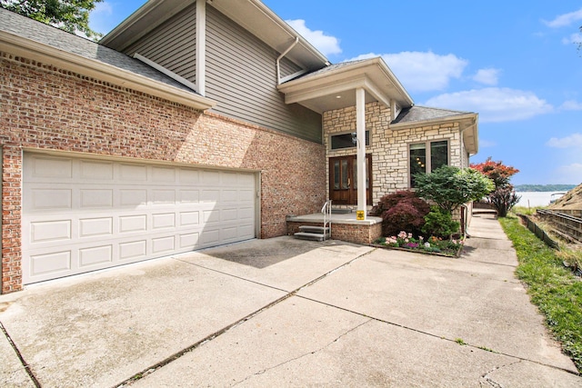 exterior space with stone siding, concrete driveway, and brick siding