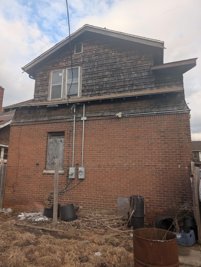 view of property exterior with brick siding