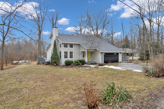 view of front of house featuring a garage, a front yard, driveway, and a chimney