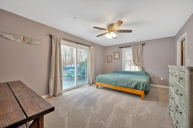 bedroom with light carpet, access to outside, ceiling fan, and baseboards