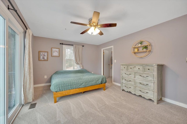 bedroom featuring light colored carpet, visible vents, and baseboards