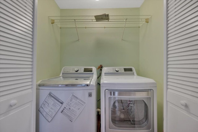 washroom featuring laundry area and washer and clothes dryer