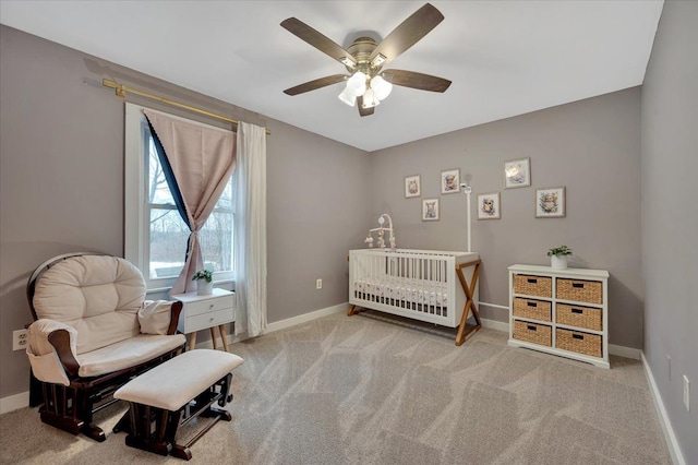 carpeted bedroom with ceiling fan and baseboards