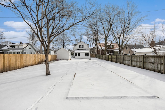 yard covered in snow with fence private yard and a residential view