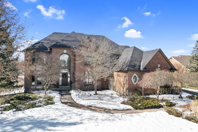 view of front of home featuring a garage and brick siding