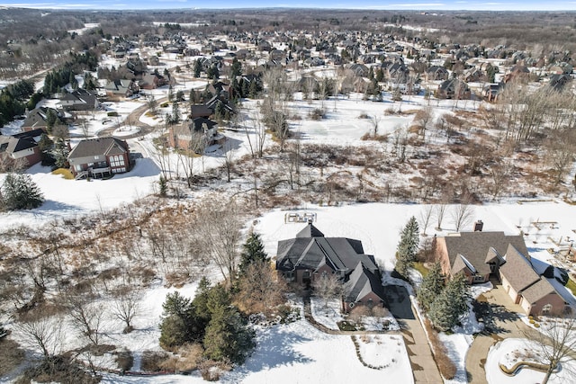 snowy aerial view with a residential view