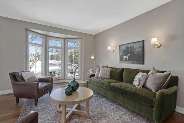 living room featuring ornamental molding, wood finished floors, and baseboards