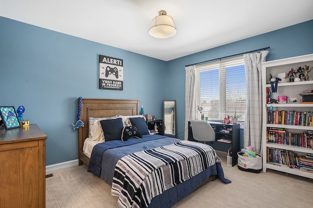 carpeted bedroom featuring baseboards