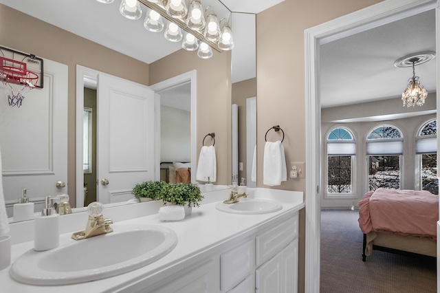 ensuite bathroom with double vanity, a sink, and ensuite bathroom