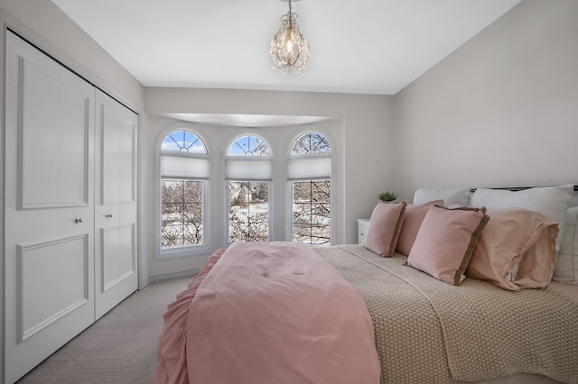 bedroom featuring light carpet and a closet