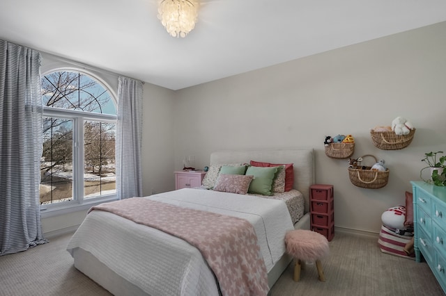 bedroom featuring multiple windows, baseboards, and carpet flooring