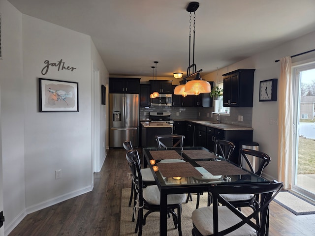 dining room with plenty of natural light, dark wood-type flooring, and baseboards