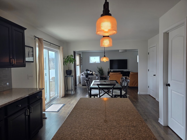 dining area featuring dark wood-style floors and baseboards