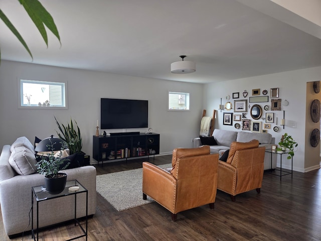 living room featuring a wealth of natural light, baseboards, and dark wood-style floors