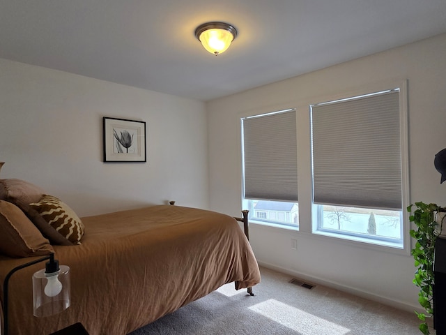 bedroom with visible vents, baseboards, and carpet