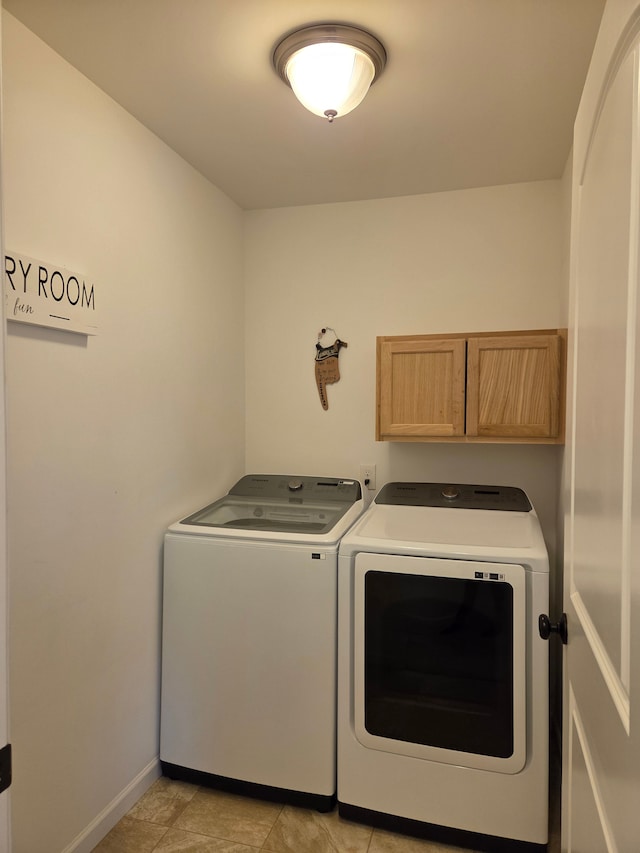 laundry room featuring cabinet space, washing machine and dryer, and baseboards