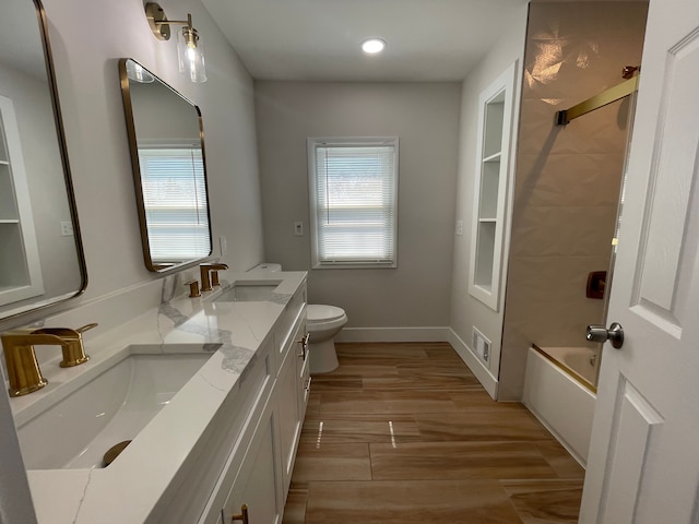 full bathroom featuring plenty of natural light, a sink, and toilet