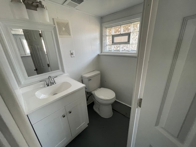 bathroom featuring visible vents, vanity, and toilet