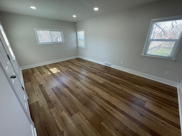 unfurnished bedroom with recessed lighting, visible vents, baseboards, and wood finished floors