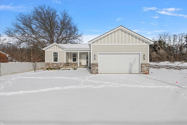 view of front of home with board and batten siding, stone siding, and a garage