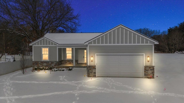 craftsman inspired home featuring stone siding, board and batten siding, and an attached garage