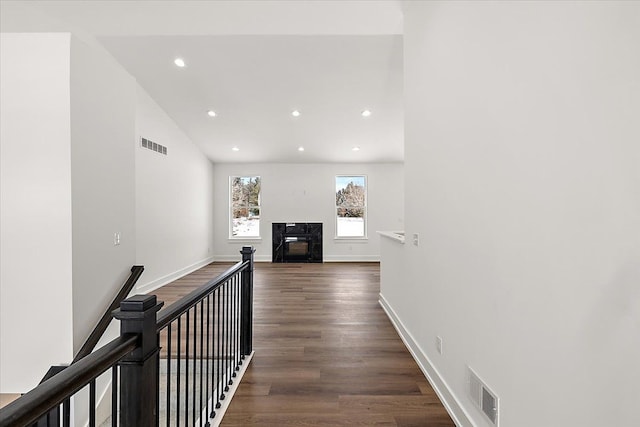 hallway with recessed lighting, visible vents, dark wood finished floors, and baseboards