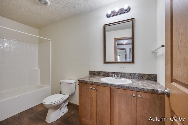 bathroom featuring visible vents, toilet, vanity, a textured ceiling, and wood finished floors