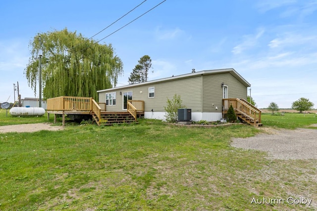 5443 Gravel Ridge Rd, Lakeview, MI 48850 - back of property featuring central AC, a wooden deck, and a yard