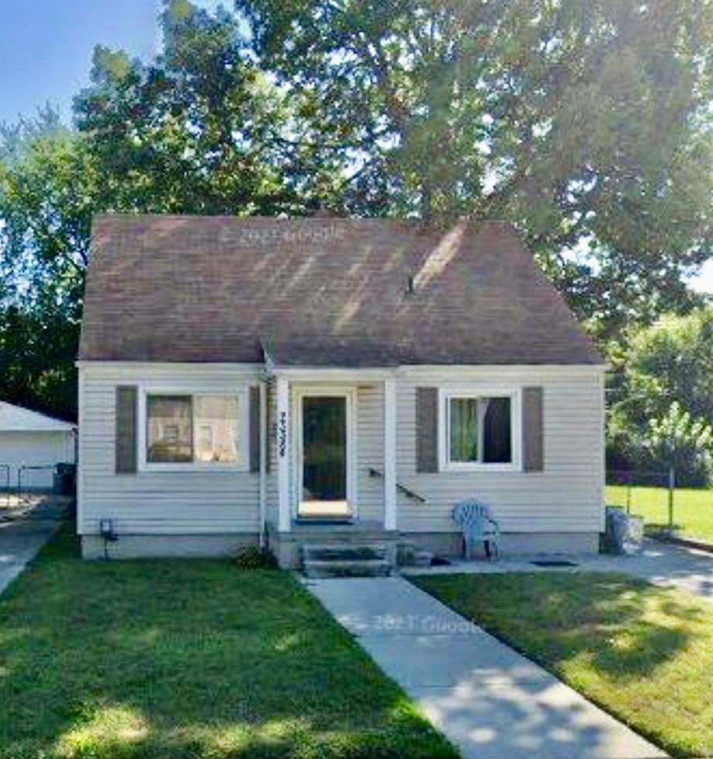 view of front of home featuring entry steps and a front lawn