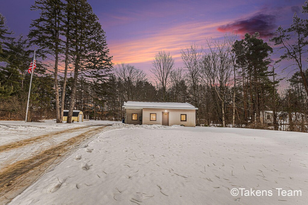 view of front of house with a storage unit and an outdoor structure