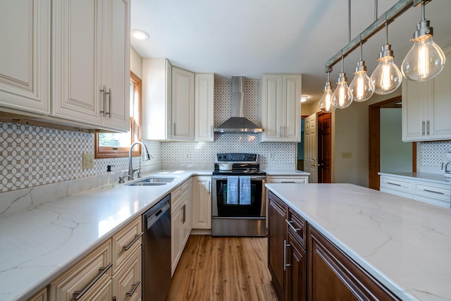 kitchen with a sink, black dishwasher, wall chimney range hood, light stone countertops, and stainless steel range with electric stovetop