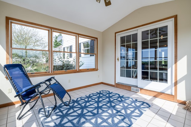 sitting room with lofted ceiling, light tile patterned floors, baseboards, and visible vents