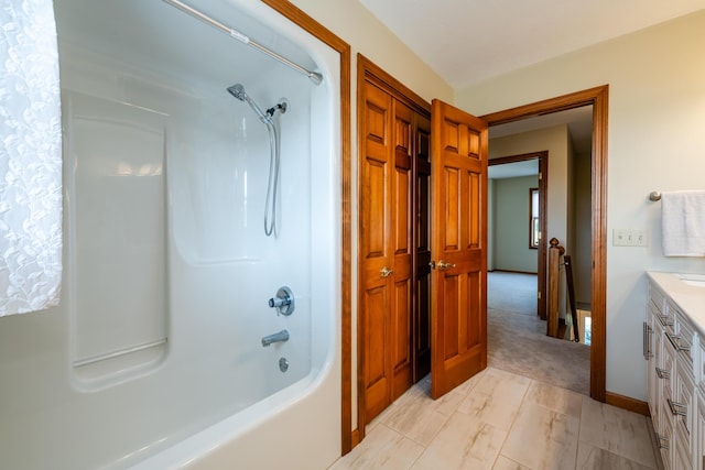 bathroom featuring shower / bath combination, baseboards, a closet, and vanity