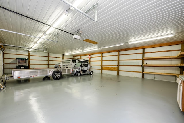 garage with metal wall and a garage door opener