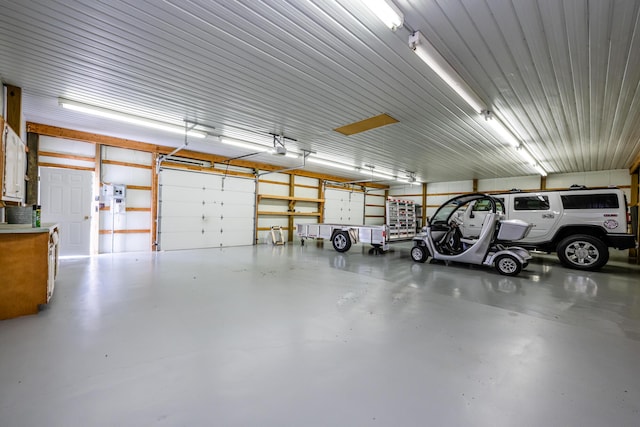 garage featuring metal wall and a garage door opener