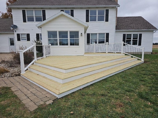 back of house with roof with shingles