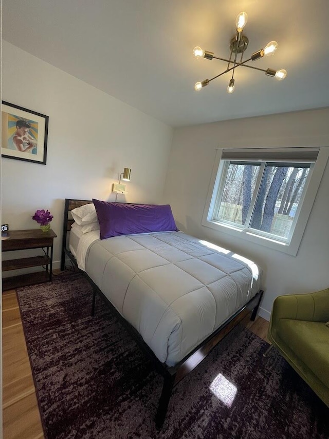 bedroom featuring baseboards and wood finished floors