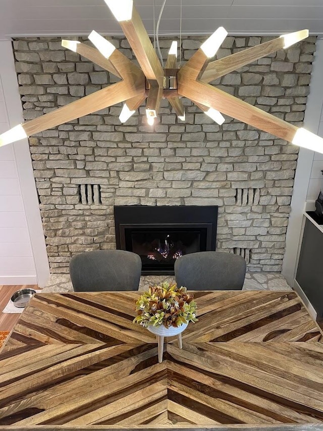 interior space with a large fireplace and wood finished floors