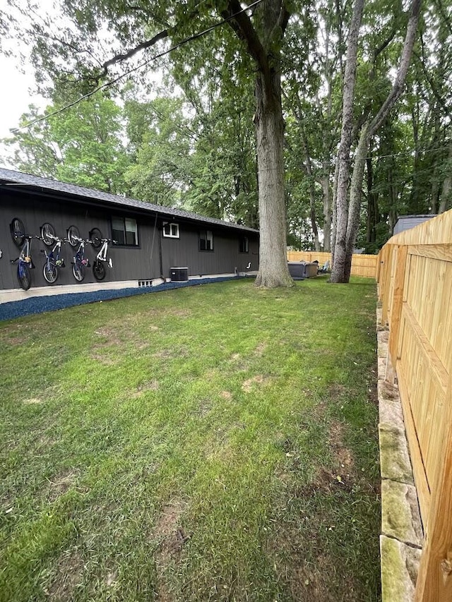 view of yard with cooling unit and a fenced backyard